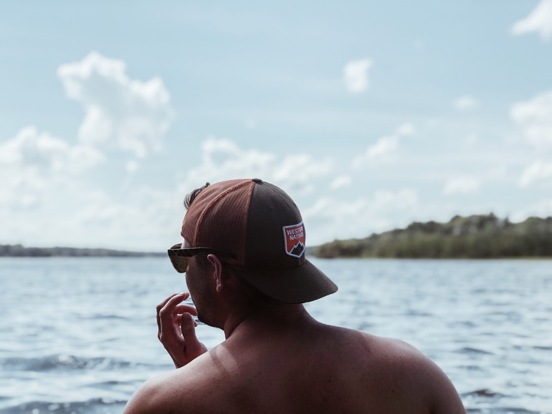 cap, sea, sunglasses, portrait, young, focus on foreground, hat, white, man, one person, water, young adult, goggles, daytime, looking out, backwards hat