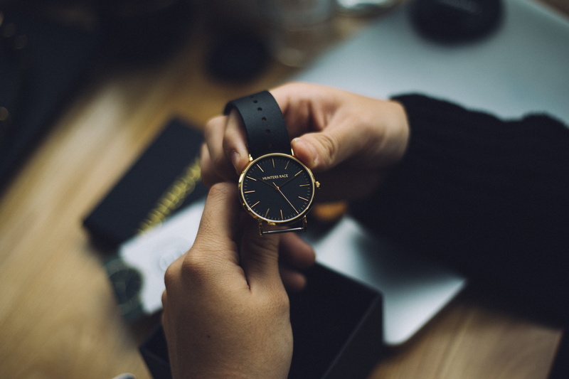 human hand, analog, time piece, human limb, time, selective focus, accuracy, person, colored, business, black, gold, occupation, design professional, round