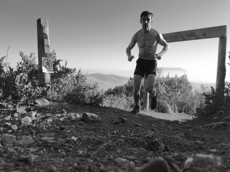 exercising, running, outdoors, young adult, nature, real people, athlete, ascent, full length, cape town, plant, dirt road, lifestyles, front view, trail running