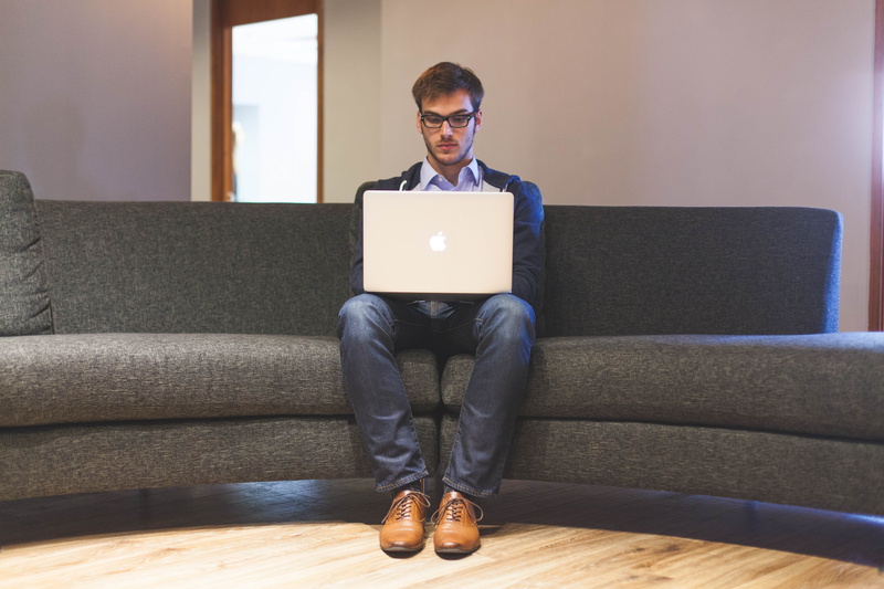 businessman, working, casual, indoors, casual clothing, front view, connection, sitting, business, corporate, eyeglasses, full length, adult, lance, wireless technology