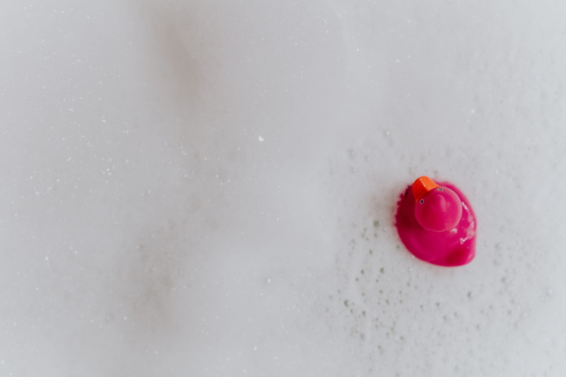 studio shot, rubber, single object, 5K, domestic bathroom, red, pink duck, bathroom, rubber duck, soap bubbles, rubber toy, day, rubber ducky, water, animal representation