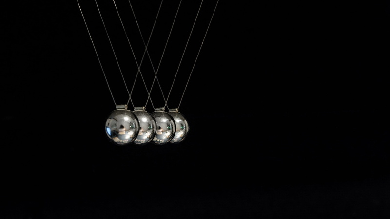 low angle view, shiny, single object, copy space, hanging, technology, no people, newton pendulum, pulse, physics, black background, science, silver colored