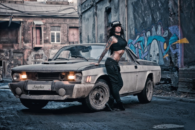 Volga, lifestyles, real people, standing, motor vehicle, car, young adult, fashion, built structure, gray, outdoors, mode of transportation, graffiti, Angelica Anderson