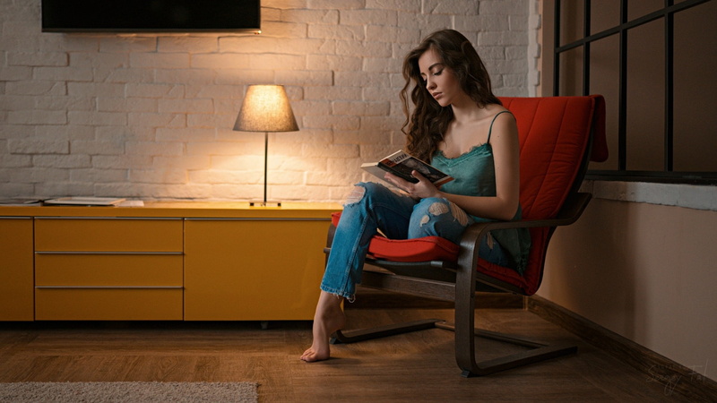 lighting equipment, adult, one person, women indoors, long hair, holding, sitting, full length, brunette, bare shoulders, chair, hairstyle, brown hair