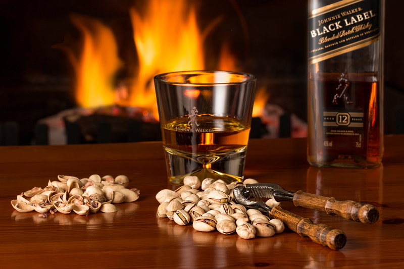 fire - natural phenomenon, snack, drink, whisky, fireside, cold weather, burning, pistachio nuts, warm, luxury, nature, wood - material, liquor, fire, still life