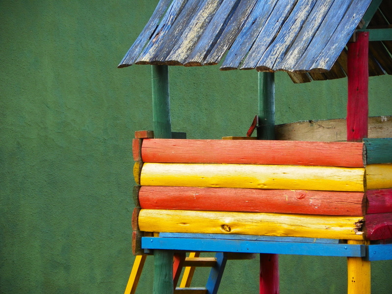 wall - building feature, wood - material, no people, high angle view, multi colored, old, day, table, green color, blue, red, in a row, absence, casita