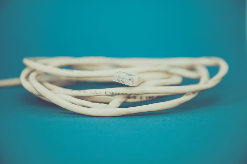 blue background, no people, close-up, western script, two objects, blue, technology, internet, ethernet, single object, communication, day, focus on foreground
