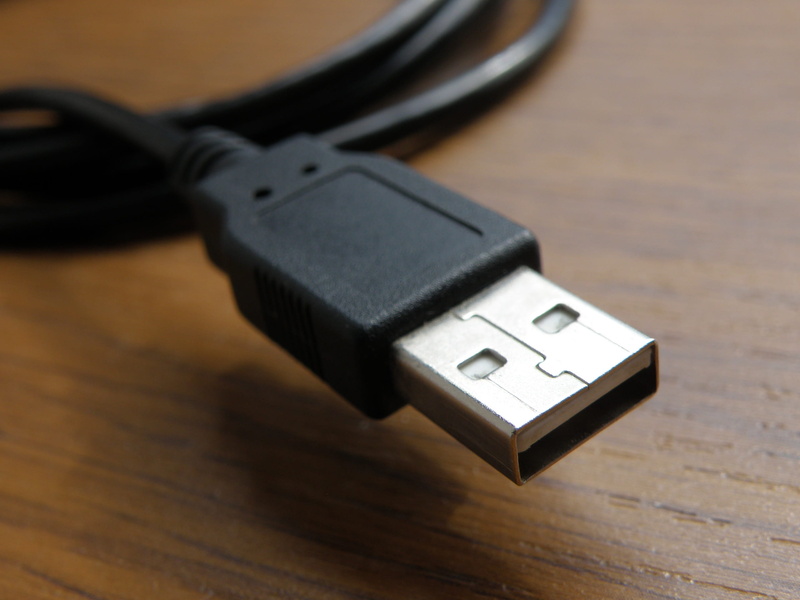 usb cable, table, safety, close-up, black color, high angle view, power supply, wood - material, no people, port, personal accessory, focus on foreground