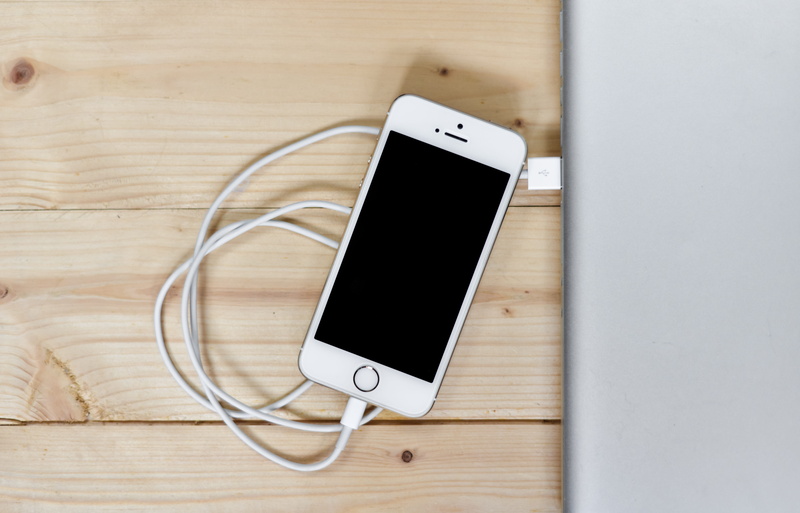 table, telephone, surface, smart phone, wireless, smartphone, brown, power supply, silver, internet, global communications, iphone, mobile phone, indoors