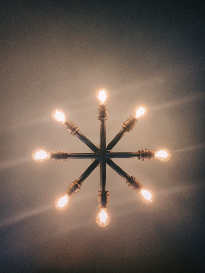 illuminated, low angle view, honey, arts culture and entertainment, stage, lens flare, symbol, light fixture, ceiling fan, indoors, launch, night, no people