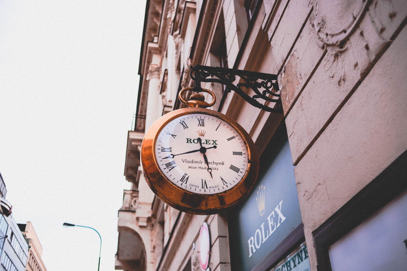 rolex, displaying, wall - building feature, store, perspective, round, instrument of time, outdoors, sign, clock, metal, abstract, lookingup, clock face