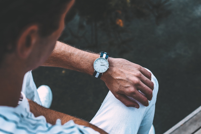 wrist, one person, flame, wristwatch, turquoise, lifestyles, clinic, person, checking the time, time, man, real people, fire, banister, outdoors, watch