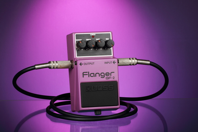 blue background, sign, effects pedal, no people, security, stomp box, studio shot, 4K, indoors, colored background, power supply, pink background, text
