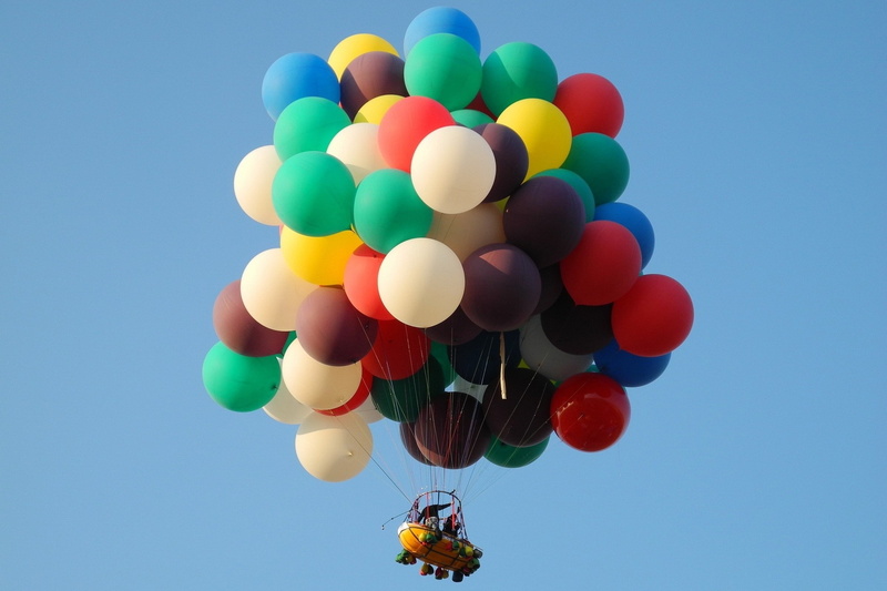 outdoors, leisure activity, clear sky, adventure, mid-air, fun, large group of objects, blue, day, moving up, bunch, multi colored, flying, balloon, nature