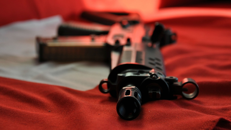 weapon, lying down, no people, assault rifle, SIG, handgun, communication, gun, indoors, rc, close-up, selective focus, Sig SG 552, ammunition, sign, violence