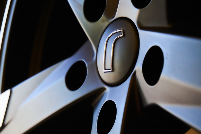 wheel, rim, black color, sports car, close, alloy, metal, speed, design, steel, no people, auto tires, alloy wheel, indoors, silver colored, vehicle, luxury