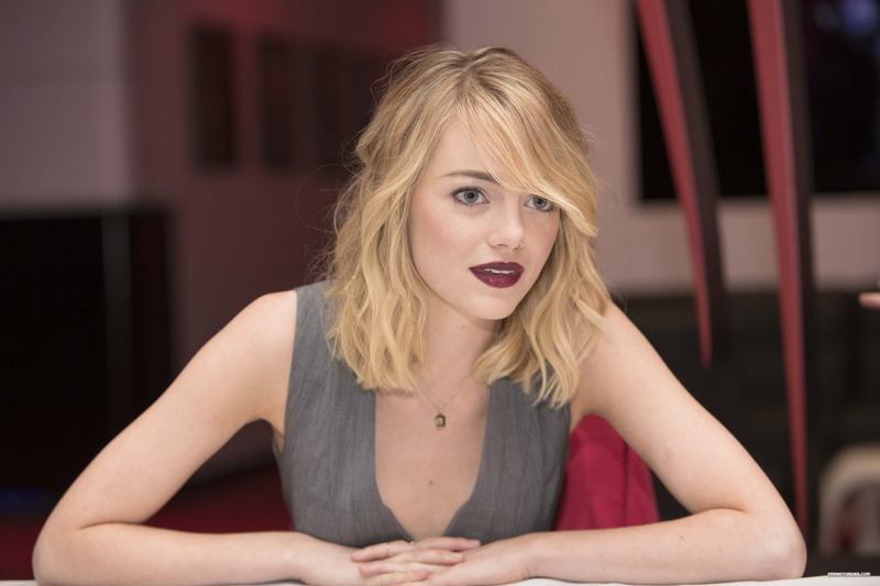 Emma Stone, mouth open, front view, lifestyles, blond hair, contemplation, long hair, woman, red lipstick, sitting, looking at camera, gray, sleeveless top