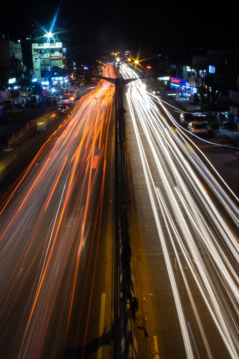 no people, architecture, town, illuminated, cityscape, traffic, tarmac, multiple lane highway, motion, city street, car, built structure, long exposure