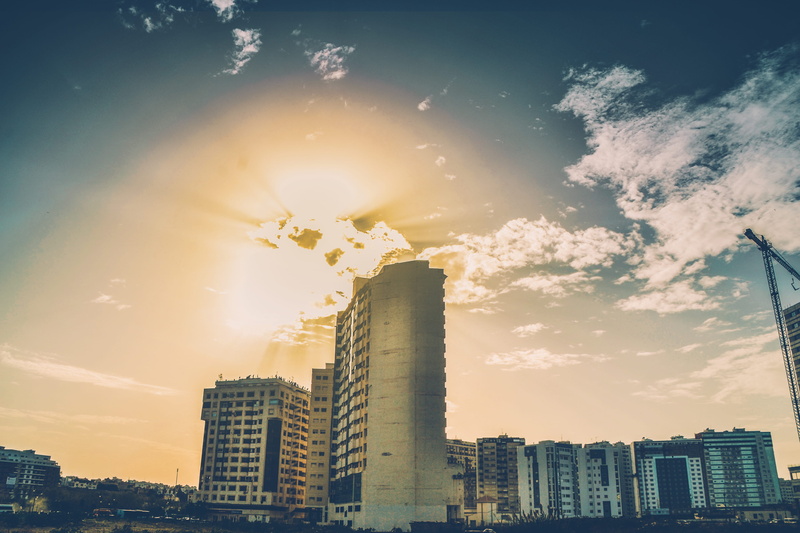 cityscape, sun, office, morocco, lens flare, office building exterior, residential district, sunlight, building, tanger city mall, skyscraper, sea, tall - high