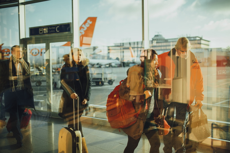 suitcase, glass - material, travel, holiday, window, outdoors, luggage, incidental people, day, departure, adult, airplane, passenger, men, arrival, reflection