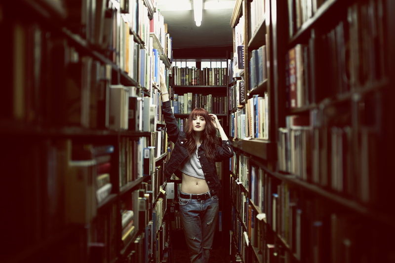 large group of objects, denim, studying, abundance, redhead, black jackets, library, book, shelf, beautiful woman, aisle, education, jeans jacket, belly