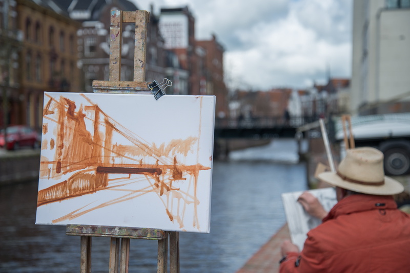sky, person, nature, water, adult, day, built structure, nautical vessel, focus on foreground, hat, building exterior, dutch, suspension, city, picture