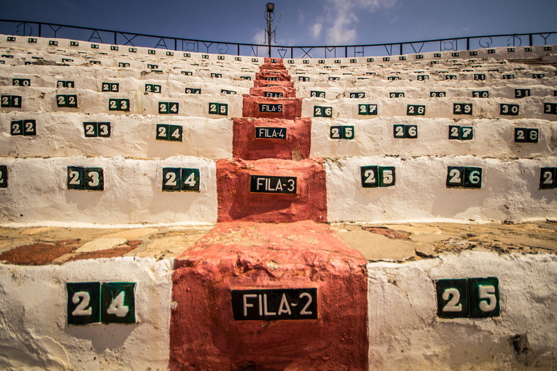 text, order, number, fighting, in a row, bull ring, fight, building exterior, nature, built structure, concrete, spain, western script, day, cloud - sky