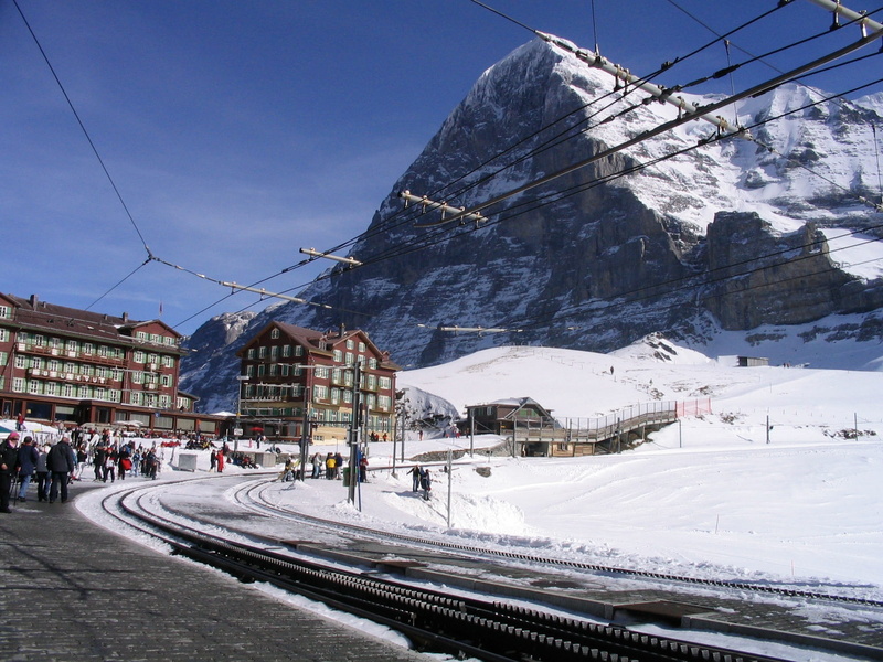 building, scenics - nature, eiger, winter, sky, outdoors, built structure, peak, building exterior, city, incidental people, snow, group of people, snowcapped mountain