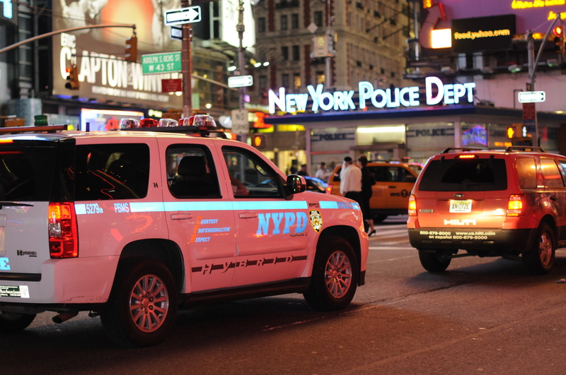 city life, machine, near, city, building exterior, police Car, taxi, motor vehicle, incidental people, text, land Vehicle, traffic, focus on foreground