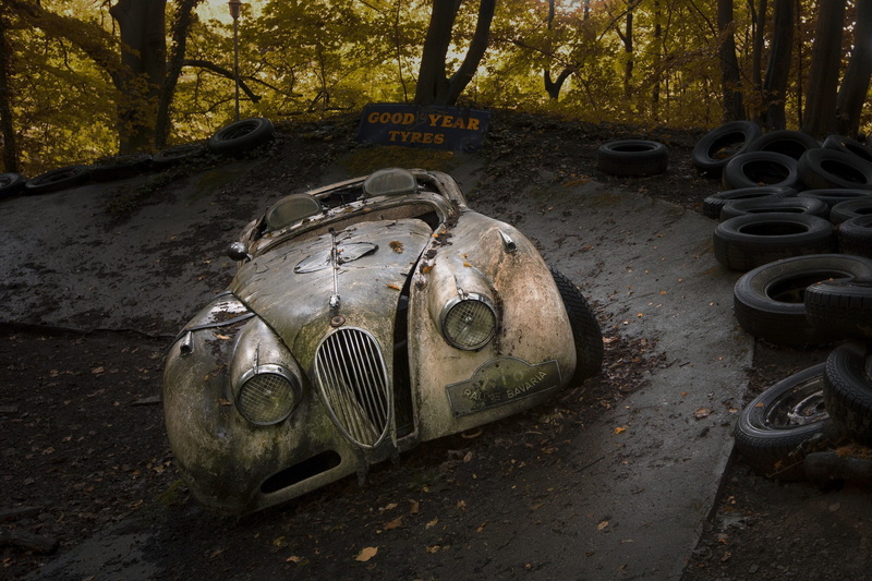 tires, tree, forest, land, brown, land vehicle, gray, stationary, wreck, plant, mode of transportation, no people, day, abandoned, outdoors, wheel, vehicle