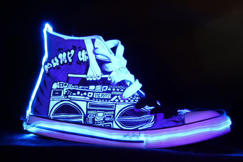 leisure, sign, western script, light art, motion, sporty, arts culture and entertainment, fila, close-up, grafitti, shoelace, limited, studio shot, dark