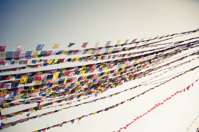 building exterior, in a row, low angle view, multi colored, pattern, decoration, hanging, built structure, nepal, abundance, serene, wind, day, copy space
