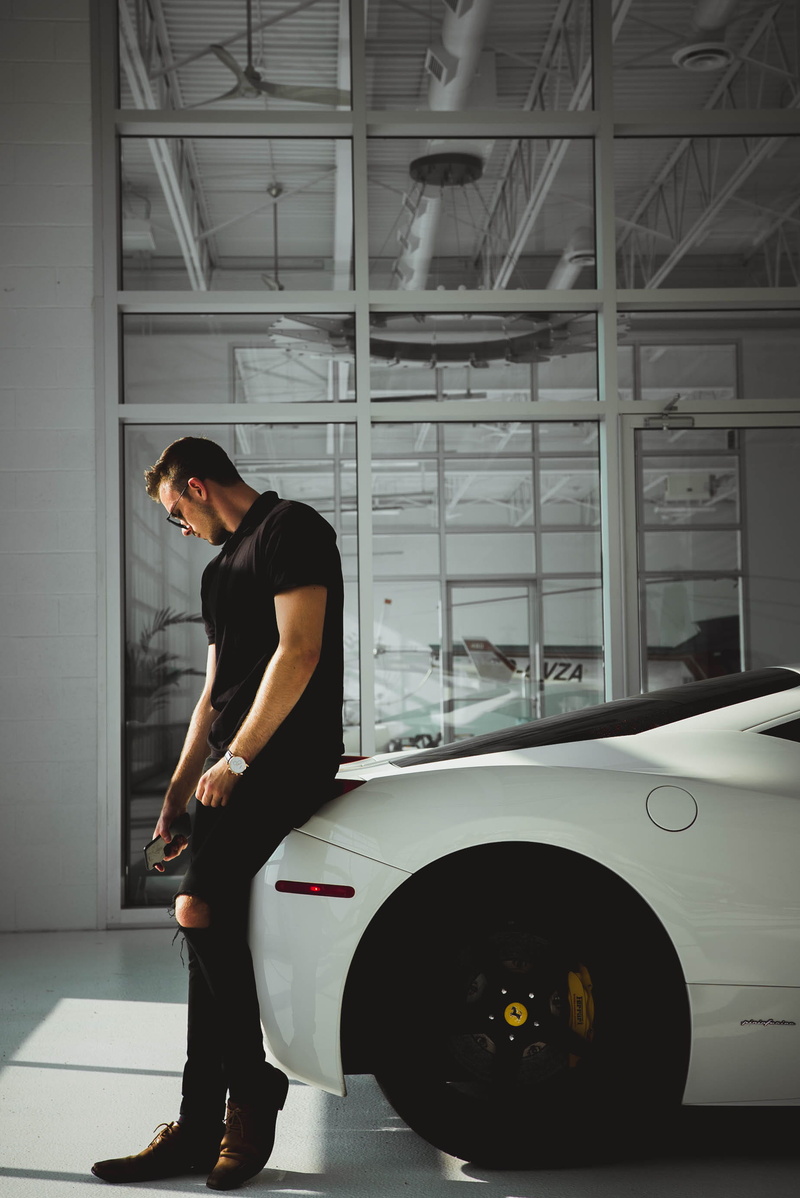 land vehicle, item, whote, day, showroom, sitting, mode of transportation, car, wheel, caucasian, lifestyles, inside, brake, young women, watch, ferrari
