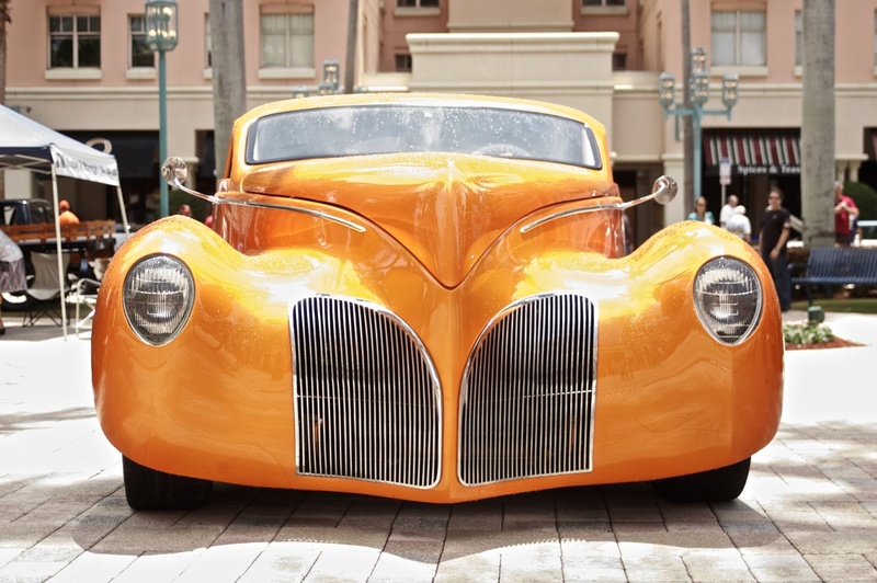 vintage car, elegance, focus on foreground, shiny, vehicle, speed, mode of transportation, old, yellow, retro Styled, outdoors, orange, architecture, automobile