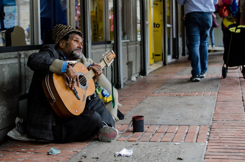 one person, sidewalk, plucking an instrument, outdoors, holding, musician, street musician, street, full length, street music, arts culture and entertainment
