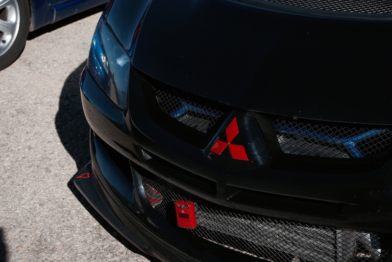 car, day, sunlight, wheel, transportation, outdoors, Mitsubishi Lancer EVO, tire, high angle view, motor vehicle, no people, city, street, luxury, stationary