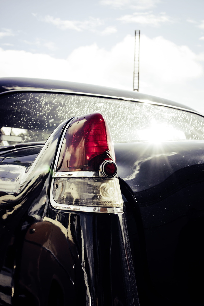 close-up, tail light, sky, cloud - sky, vintage, no people, mode of transportation, antique, classic car, mirror, outdoors, car, sunlight, glass - material