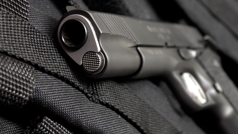 selective focus, handgun, warning sign, indoors, aggression, textile, close-up, crime, metal, violence, security, safety, communication, gun, no people