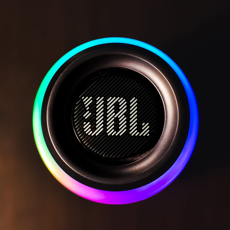 jbl, communication, single object, bright, glowing, illuminated, black color, black background, close-up, technology, directly above, indoors, arts culture and entertainment