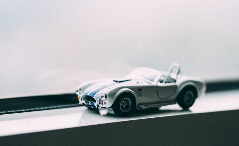 single object, photo, transportation, selective focus, two objects, focus on foreground, mode of transportation, silver colored, motor vehicle, sports