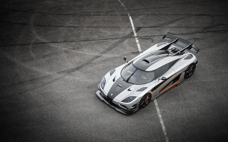 black, car, outdoors, land vehicle, transportation, road, no people, city, single object, speed, racecar, sports race, luxury, asphalt, motorsport, motor vehicle