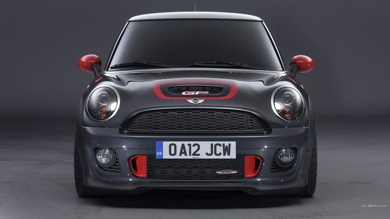 motor vehicle, front view, black background, transportation, Mini JCW, indoors, silver colored, speed, land vehicle, red, studio shot, retro styled, motion