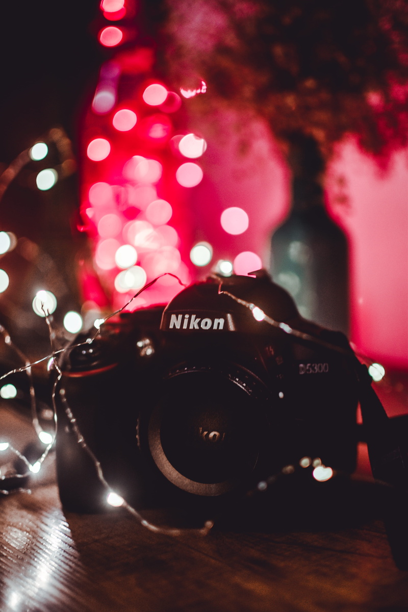 camera equipment, colors, night, christmas decoration, design, lights, black, table, defocused, decoration, 5K, focus on foreground, blurred background