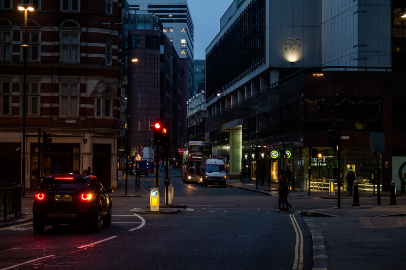transportation, transportation system, buildings, land vehicle, street lamps, city street, night, motion, office building exterior, building, dark, roadway