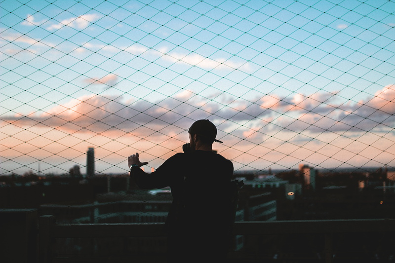 boundary, outdoors, standing, man, solo, fence, one person, person, 5K, sky, barrier, three quarter length, nature, architecture, rear view, leisure activity