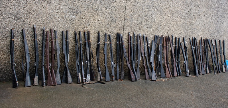 side by side, cadet gun, day, riffles, land, gun, arrangement, food and drink, sand, outdoors, beach, large group of objects, nature, food, cadet riffles