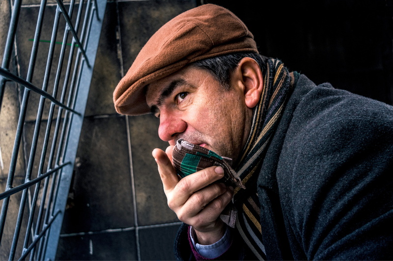 look, gate, holding, adult, grill, clothing, blue, window, hat, mesh, neat, males, 5K, finger, cadet, men, point, brown, wearing, cap, one person, mature men