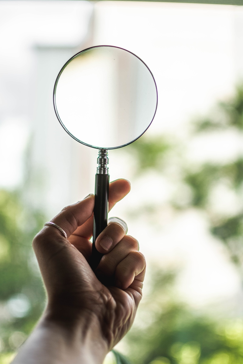 shift, outdoors, focus on foreground, real people, magnifying glass, glass, holding, searching, scrutiny, 5K, close-up, human hand, finger, glass - material