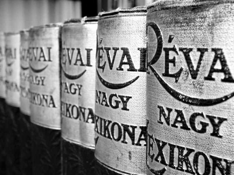 container, message, cylinder, alcohol, script, text, shelf, book, non-western script, winemaking, food and drink, focus on foreground, refreshment, barrel
