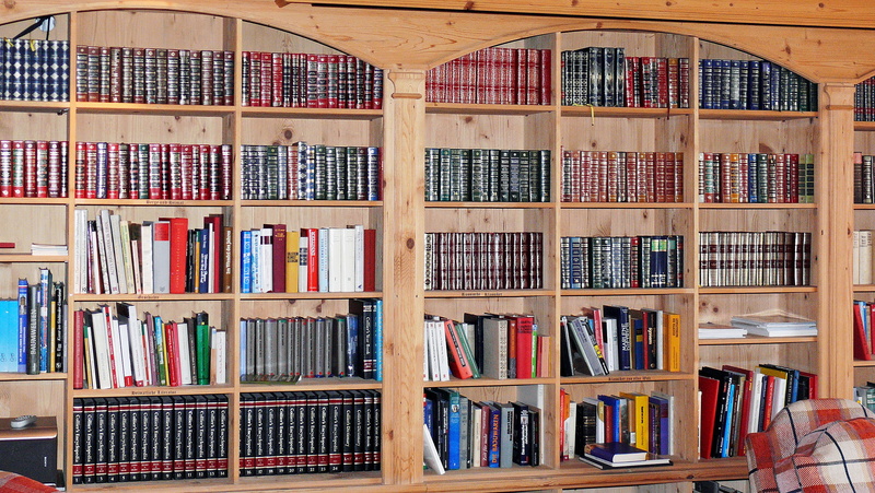 indoors, fabric, books, seat, textbook, tissue, work rooms, table and chairs, still life, read, library, sofa, living room, arrangement, wooden, large group of objects